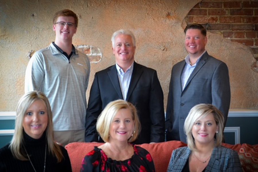 Meet Our Team - Jackson & Gray Insurance Team Smiling and Posing Together Inside for a Photo